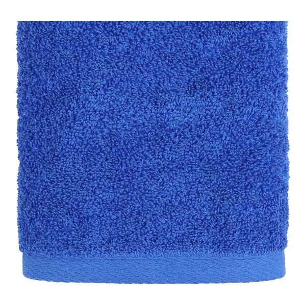 A blue hand towel with a white border.