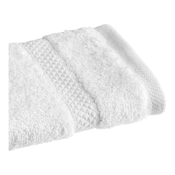 A white Magnificence Pima cotton washcloth folded on a white surface.