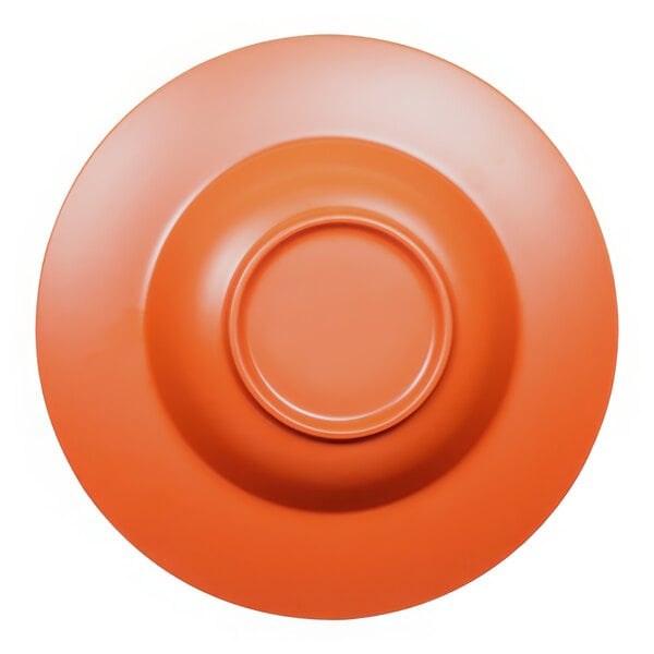 An orange melamine pasta bowl with a red reactive glaze on a surface.