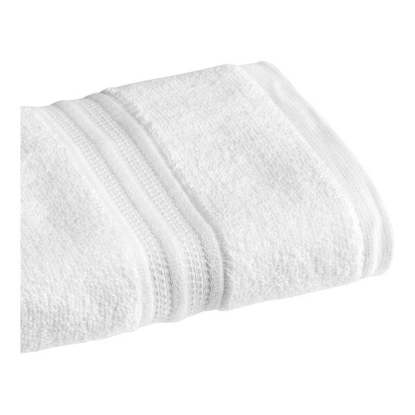 A folded white 1888 Mills Sweet South hand towel with a white stripe.