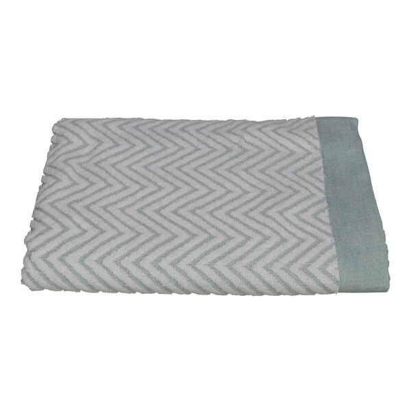 A folded white pool towel with a light blue chevron pattern.