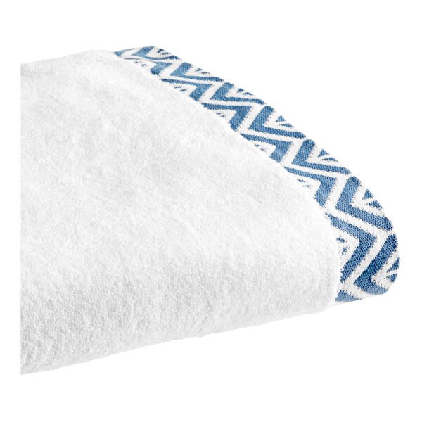 A white towel with a blue chevron pattern.