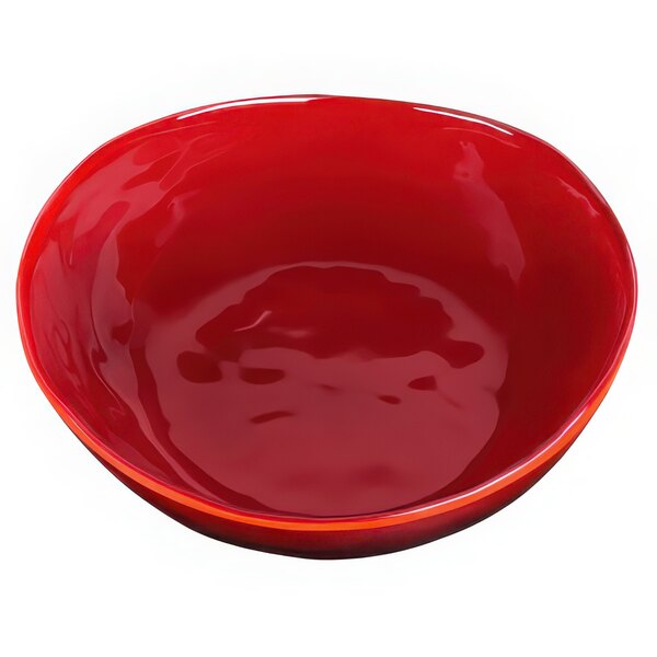 A red bowl with an irregular shape and reactive glaze finish on a white background.