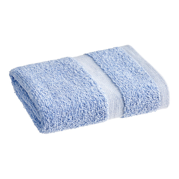 A blue 1888 Mills Fibertone hand towel with a white stripe folded up.