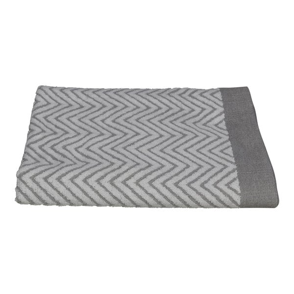 A grey and white towel with a chevron pattern.