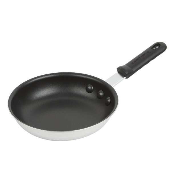 A Carlisle black aluminum frying pan with a black Dura-Kool handle.
