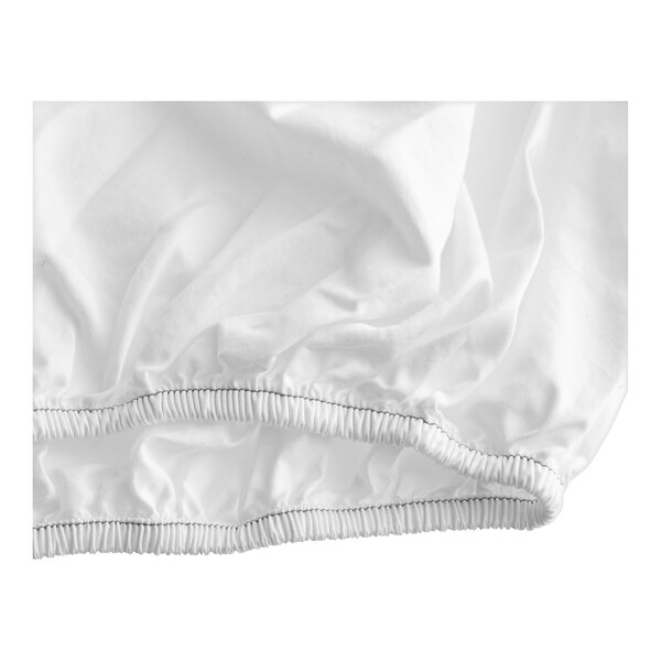A white 1888 Mills Naked T-300 fitted sheet with a ruffled edge.
