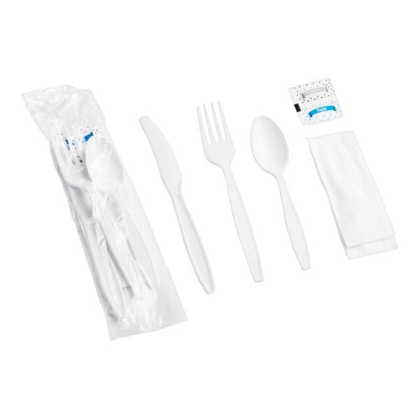 A white plastic wrapped cutlery set with napkin and salt and pepper packets.