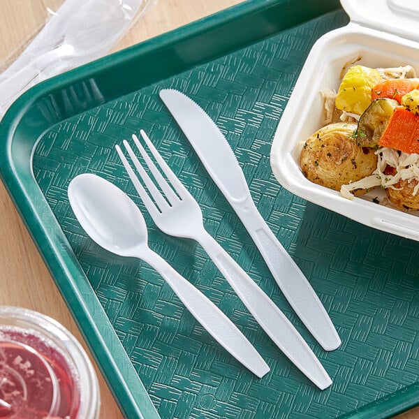 A white tray with wrapped plastic forks and spoons.