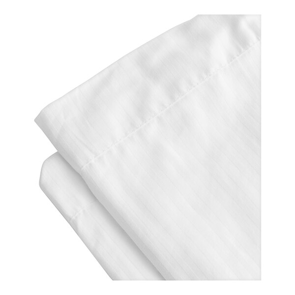 A close-up of a folded 1888 Mills Magnificence white duvet cover.