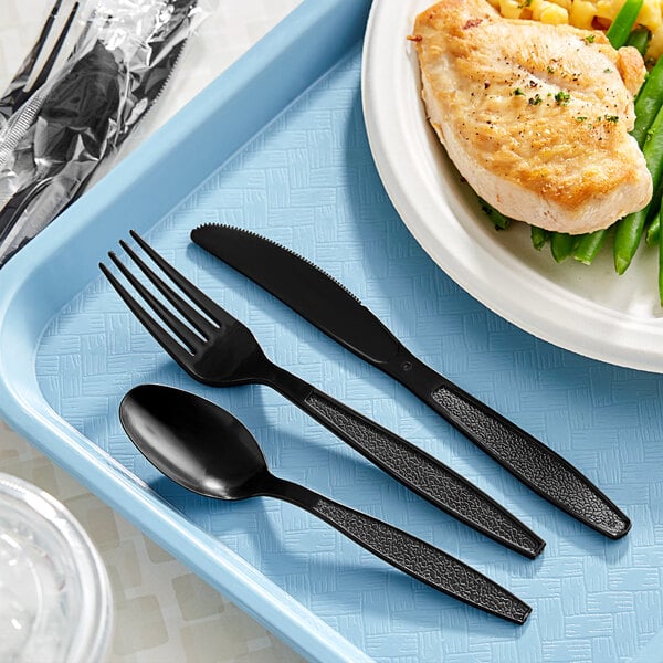 A black plastic tray with wrapped cutlery including a fork, spoon, and knife.