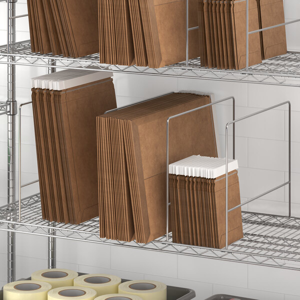 A Regency wire shelf with brown folders and rolls of tape.