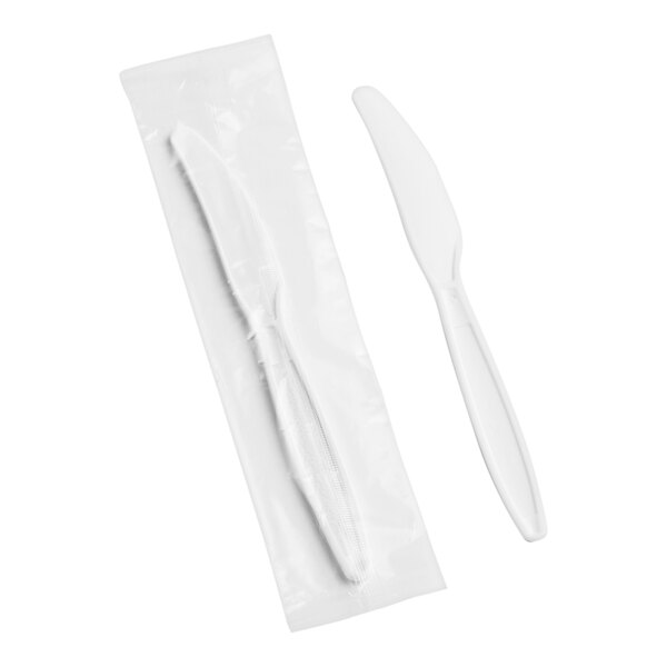 A white plastic knife in a plastic bag.