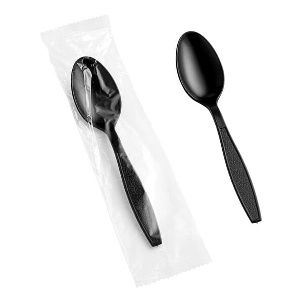 A black plastic Choice wrapped teaspoon in plastic packaging.