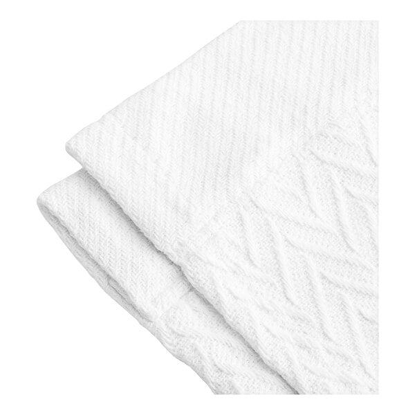 A close-up of a white herringbone blanket.