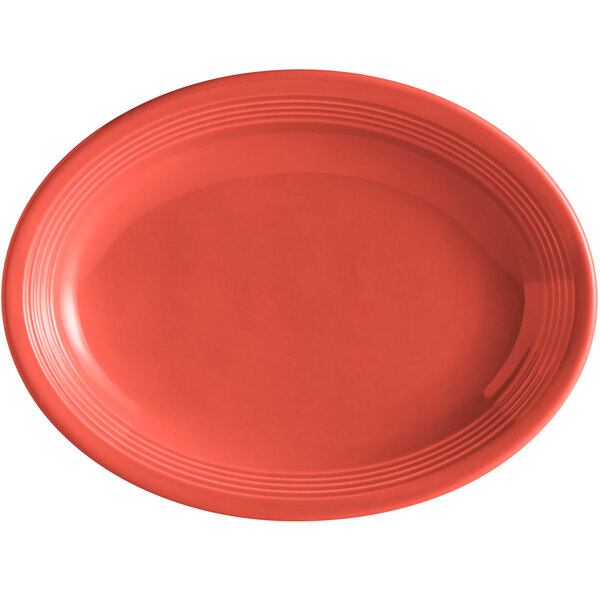 A red oval Tuxton China platter with a white background.