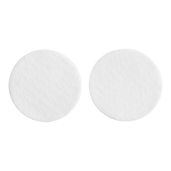 Two white round Toddy felt filters.