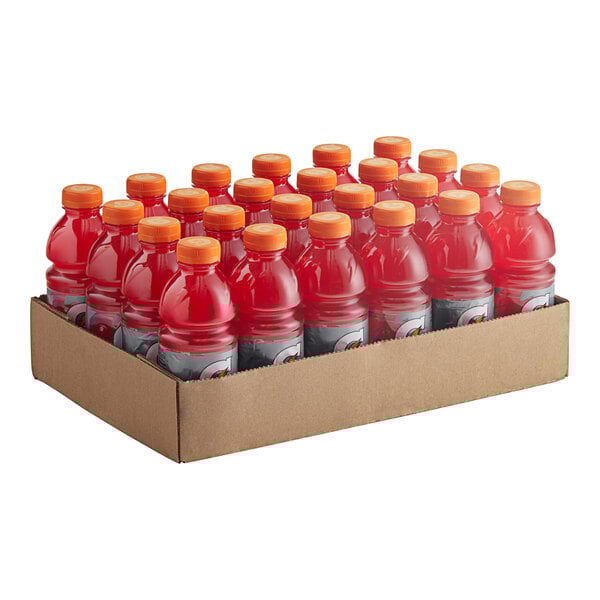 A cardboard box with a group of red Gatorade sports drink bottles.