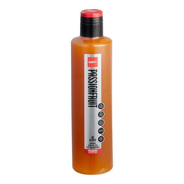 A close up of a SHOTT Passionfruit syrup bottle with a red lid.