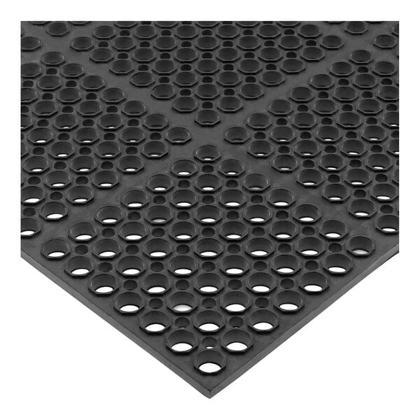 A black San Jamar Tuf-Mat with holes in it.
