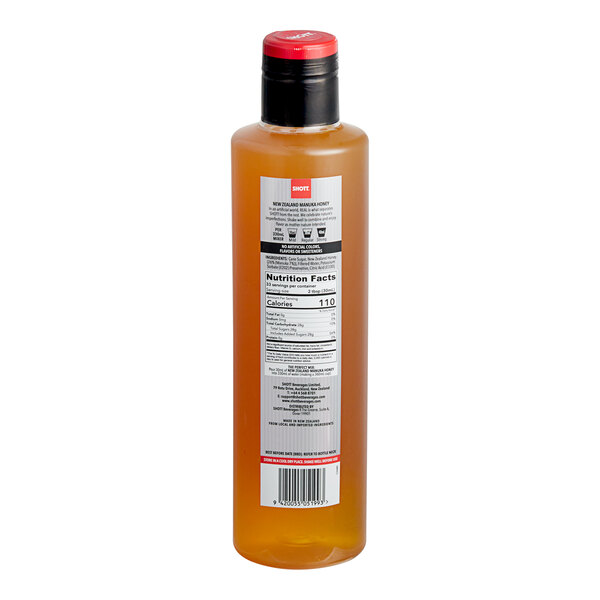 A bottle of SHOTT Manuka Honey flavoring syrup with a label.