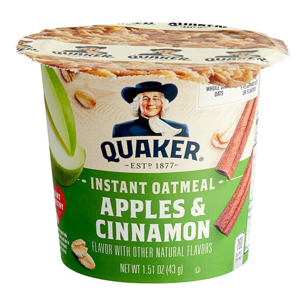 A Quaker Apples and Cinnamon instant oatmeal cup on a table.