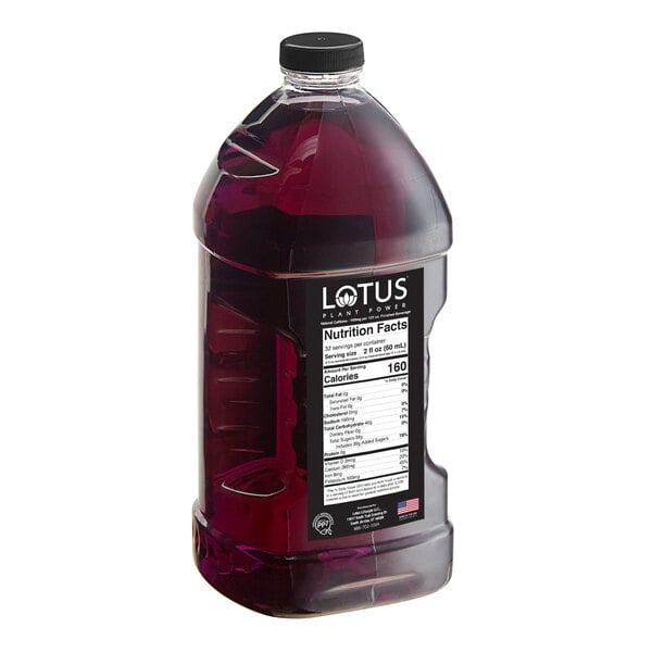 A large clear plastic bottle filled with a dark purple liquid, featuring a black label with nutrition facts and the brand name 'Lotus' visible.
