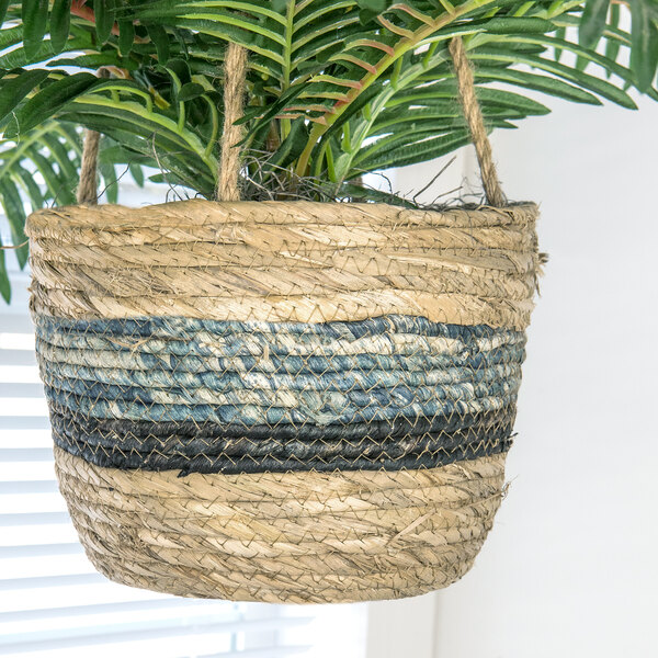 A close-up of a 30" artificial Phoenix palm in a woven tri-color hanging basket.
