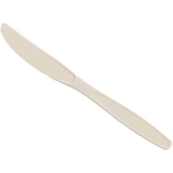 A beige heavy weight plastic knife with a white handle.