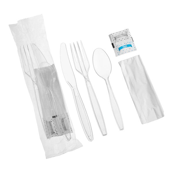 A clear heavy weight plastic cutlery pack including a fork, knife, spoon, napkin, and salt and pepper packets.