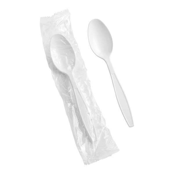 A white heavy weight polystyrene plastic teaspoon, with one spoon individually wrapped in plastic and another unwrapped.