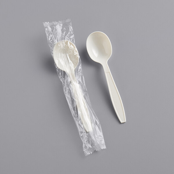 A wrapped beige plastic soup spoon.