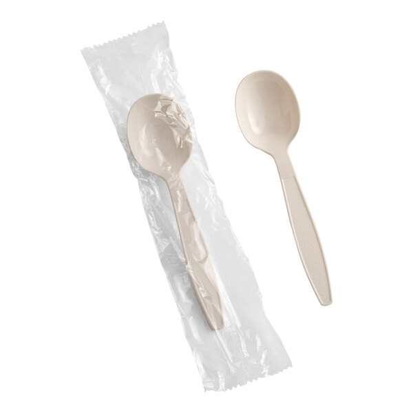 A beige heavy weight polystyrene plastic soup spoon, with one spoon individually wrapped in plastic and one unwrapped.