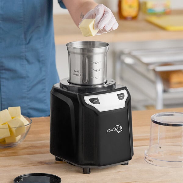 A black AvaMix commercial spice grinder with a stainless steel bowl and control buttons on the front.