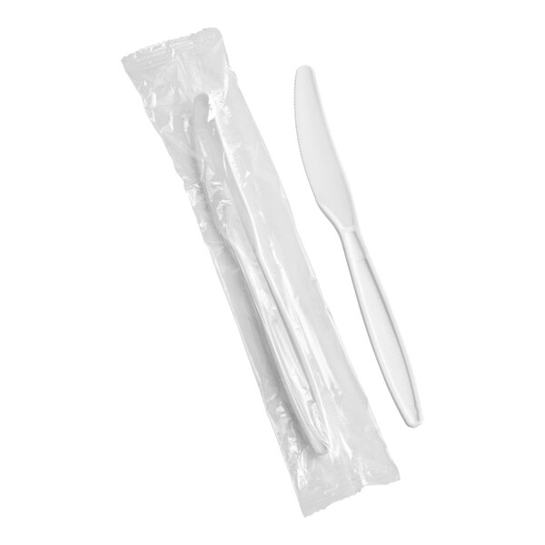 A white heavy weight polystyrene plastic knife, with one shown individually and another wrapped in plastic packaging.