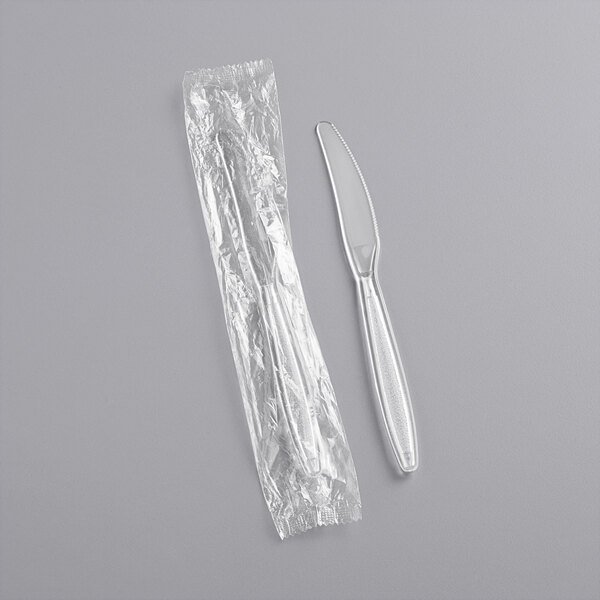 A clear plastic wrapped silver knife.