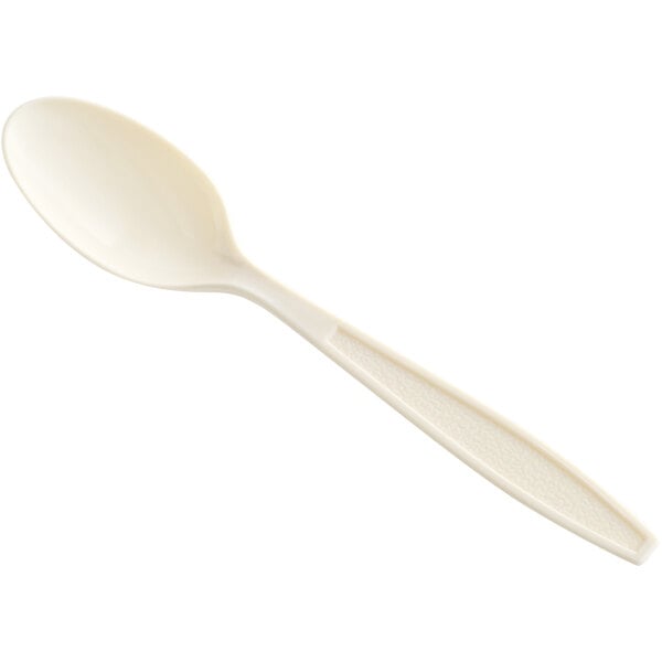A close-up of a beige plastic Choice teaspoon.