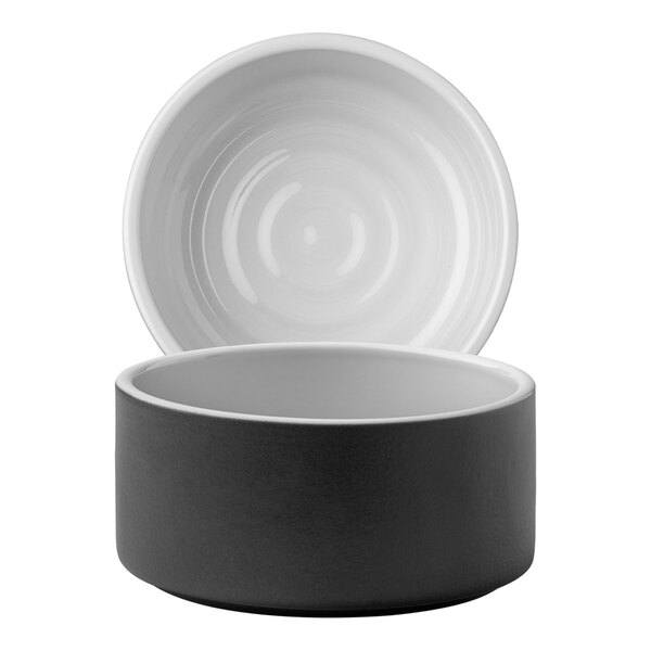 A close-up of a white and black bowl with a lid.