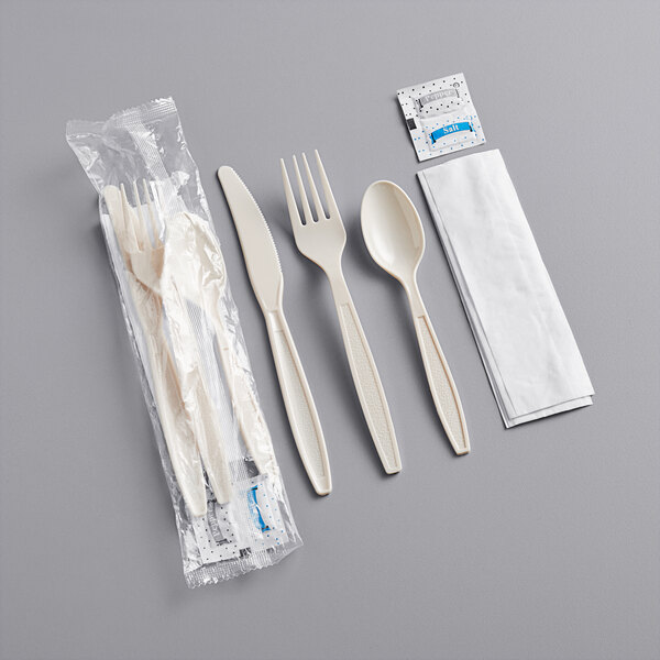 A beige wrapped plastic utensil set with a spoon and fork inside.
