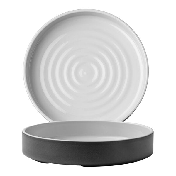 A white stoneware bowl with a black rim.