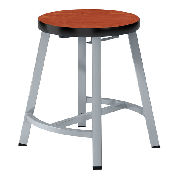 A round wood National Public Seating lab stool with metal legs.