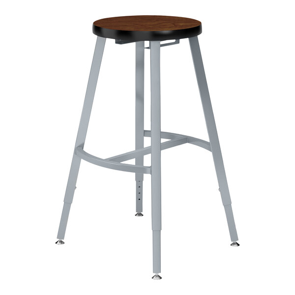 A National Public Seating Titan lab stool with a Montana Walnut high-pressure laminate seat.