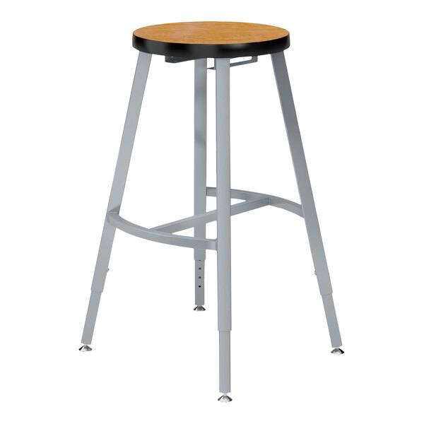 A National Public Seating Titan lab stool with a wooden seat and metal legs.