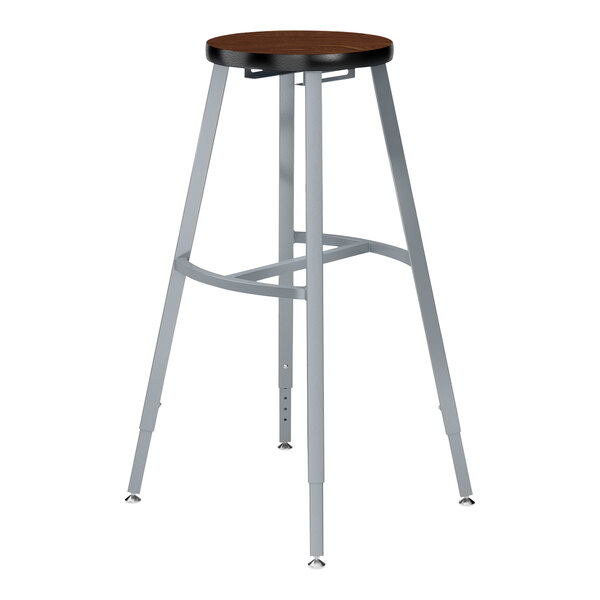 A National Public Seating Titan lab stool with a Montana walnut high-pressure laminate seat and metal legs.