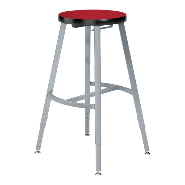 A National Public Seating lab stool with a hollyberry red high-pressure laminate seat and metal legs.