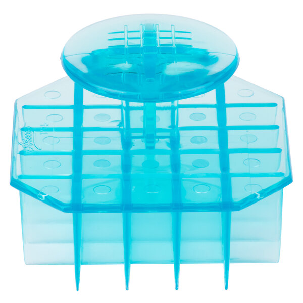 A blue plastic container with a lid holding an Ateco Mexican bread stamp with a waffle design.