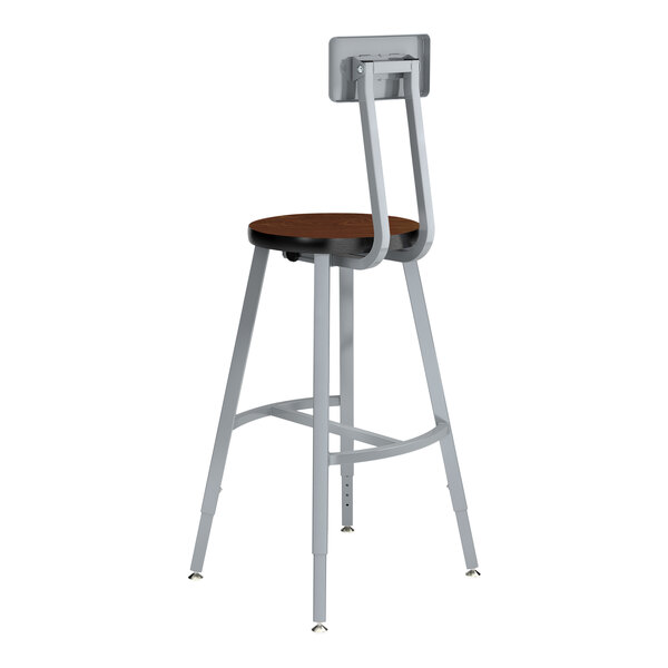 A National Public Seating Titan lab stool with a Montana walnut high-pressure laminate seat and backrest made of steel and MDF.