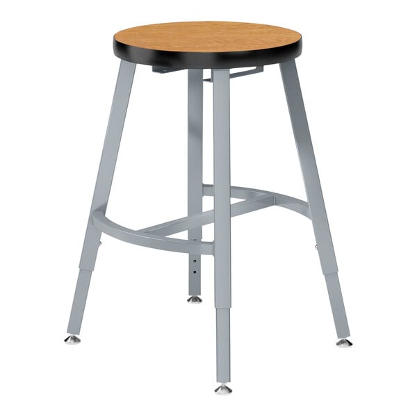 A National Public Seating Titan lab stool with a Bannister Oak seat and metal legs.