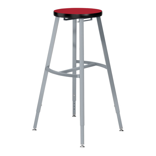 A National Public Seating lab stool with a hollyberry red seat and metal frame.