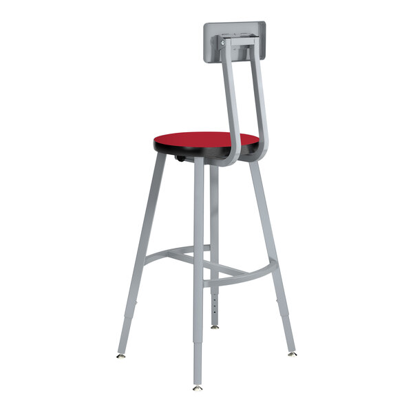 A gray National Public Seating lab stool with a metal frame and hollyberry red seat and backrest.